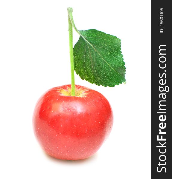 Ripe red apple with green leaf. Isolated on white background.