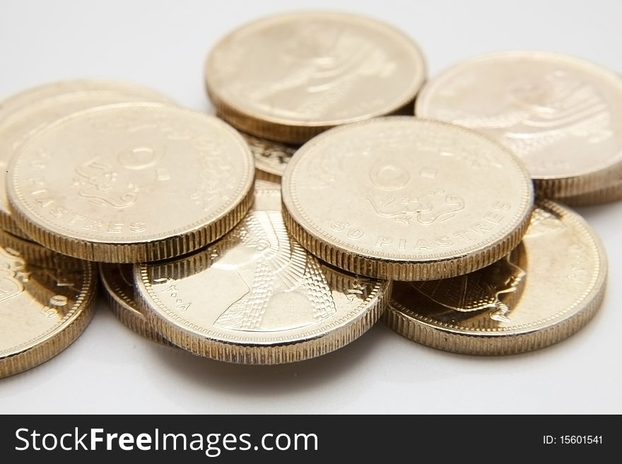 Gold coins are on a white background. piastres