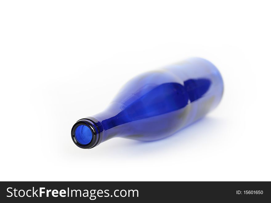 Blue glass empty bottle lying on white background. Blue glass empty bottle lying on white background