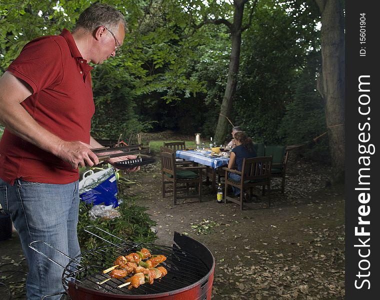 Bbq in the garden with man on foreground