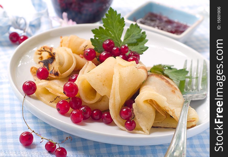 Pancakes with red currant jam for breakfast. Pancakes with red currant jam for breakfast