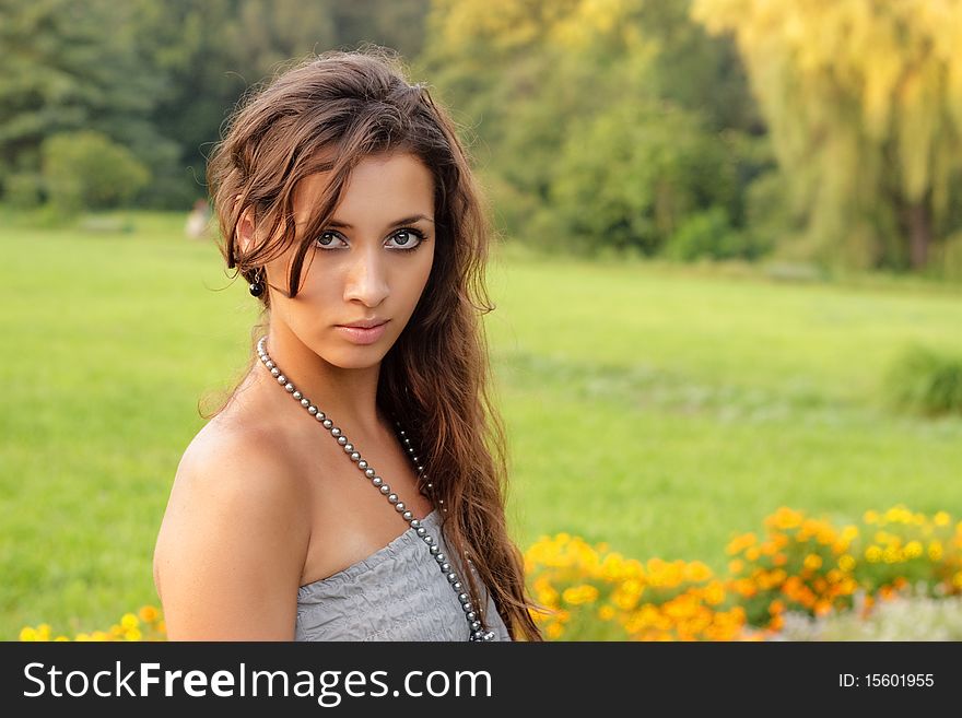 Beautiful young girl standing in the park