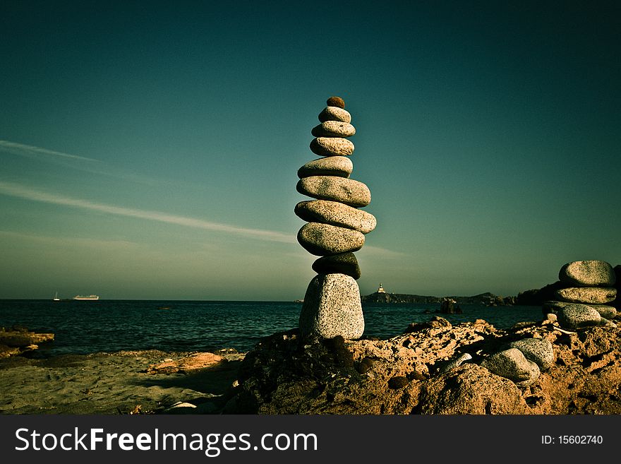Tower of pebbles on the beach of Sardinia. Tower of pebbles on the beach of Sardinia