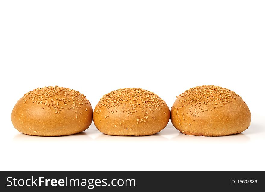 Three sesame seed buns isolated on white