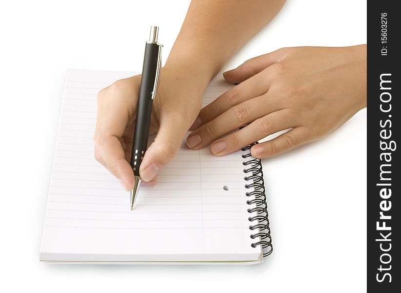 Pen in hand writing on the notebook isolated on white