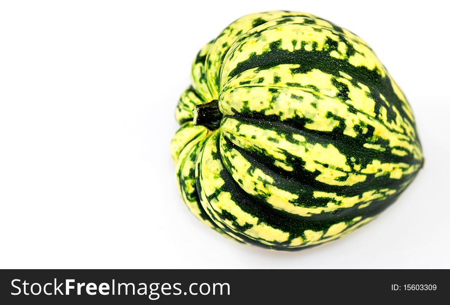 Yellow and green coloured harlequin pumpkin, isolated on white