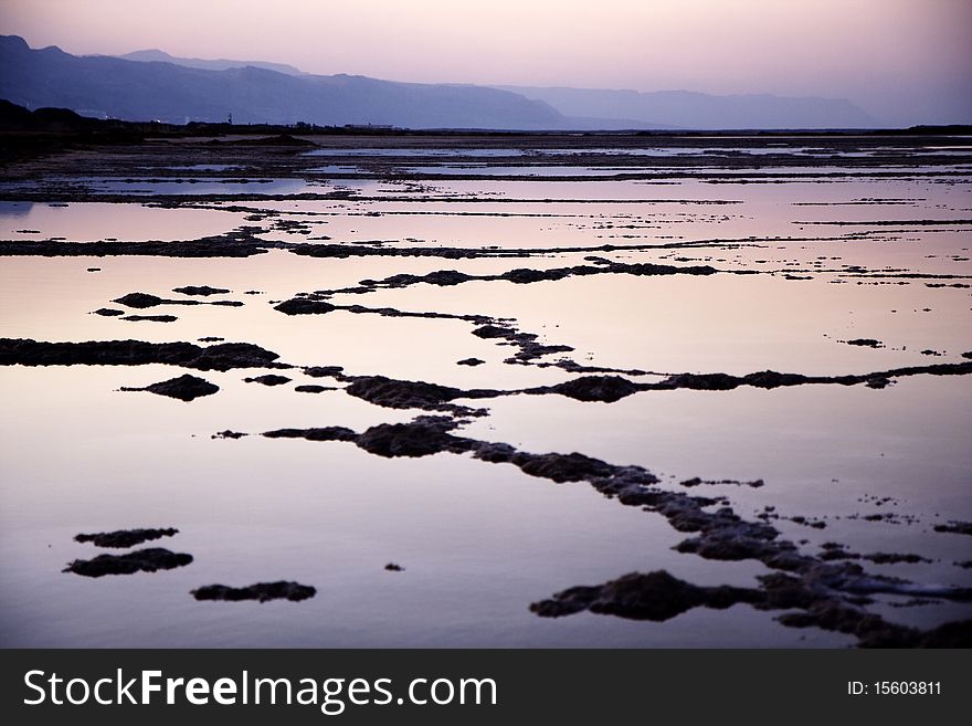 The water of the dead sea with the Jordan mountains at sunset. The water of the dead sea with the Jordan mountains at sunset