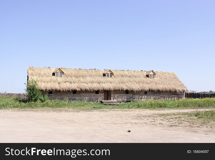 Old village house with thatch and small windows. Old village house with thatch and small windows