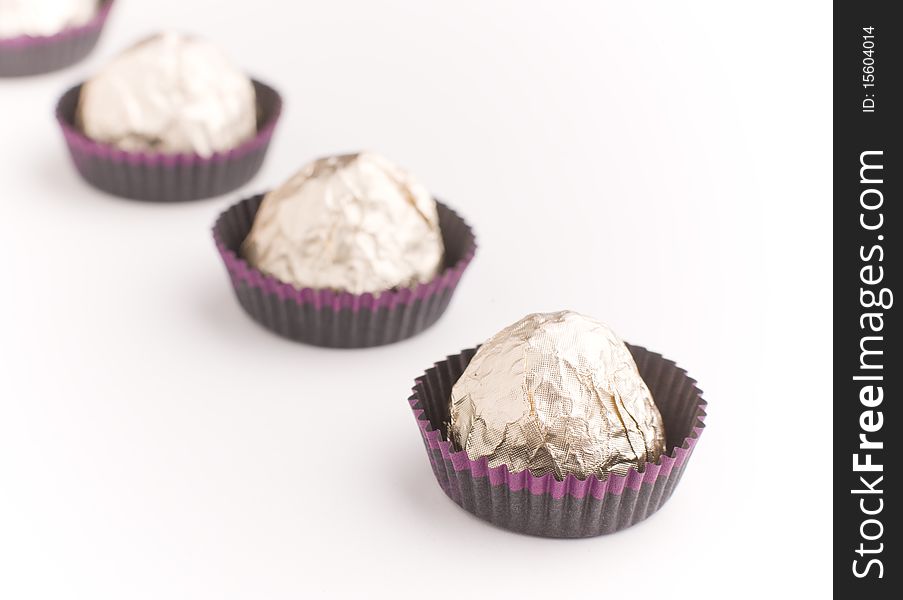 Choco  Candies In Golden Foil On Table