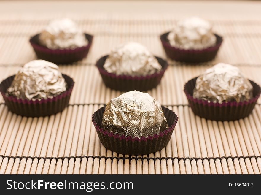 Choco  candies in golden foil on table