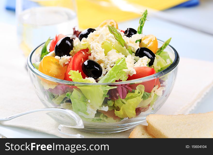 Fresh greek salad in a glass bowl