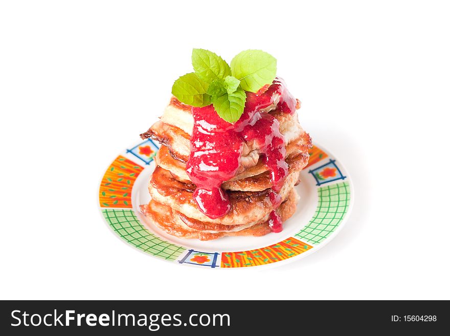 Pancake stack with fresh raspbery sauce and mint isolated on white