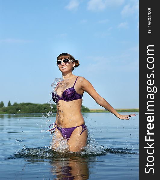 The girl in bikini in lake.