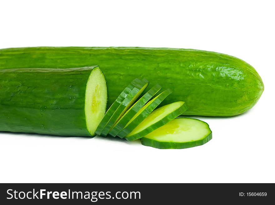 Two cucumbers and slices isolated on white background