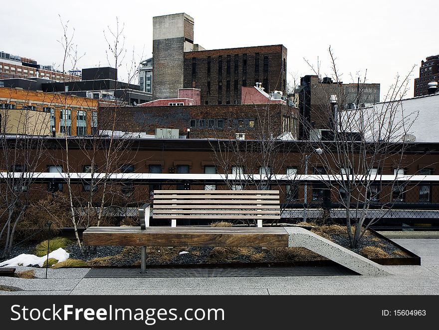 High Line park in Manhattan, New York with the city layers and a bench. High Line park in Manhattan, New York with the city layers and a bench