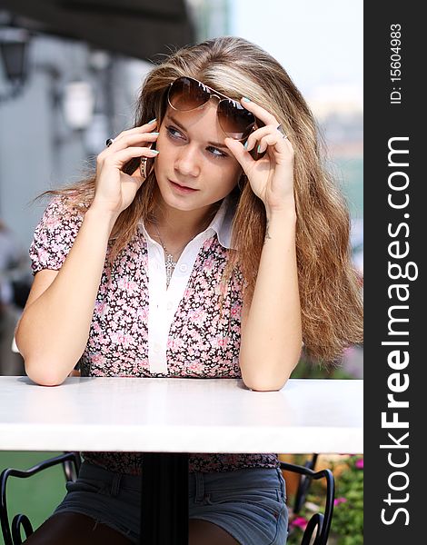 Happy young lady talking on mobile phone