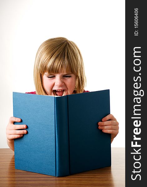 A vertical image of a pretty young girl shouting over her book isolated on a white background. A vertical image of a pretty young girl shouting over her book isolated on a white background