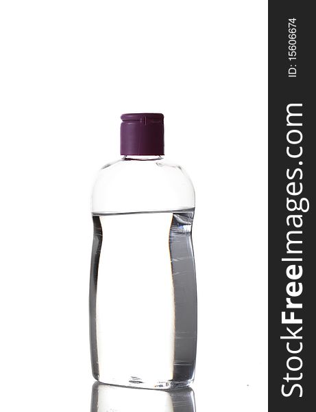 Bottle with fluid and a violet cap isolated on white