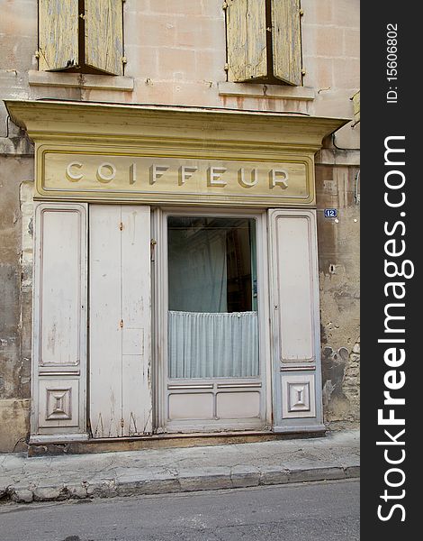 Old French coiffeur shop frontage on a road