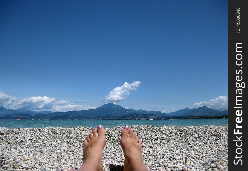 Relaxing on the pebble beach at Garda Lake