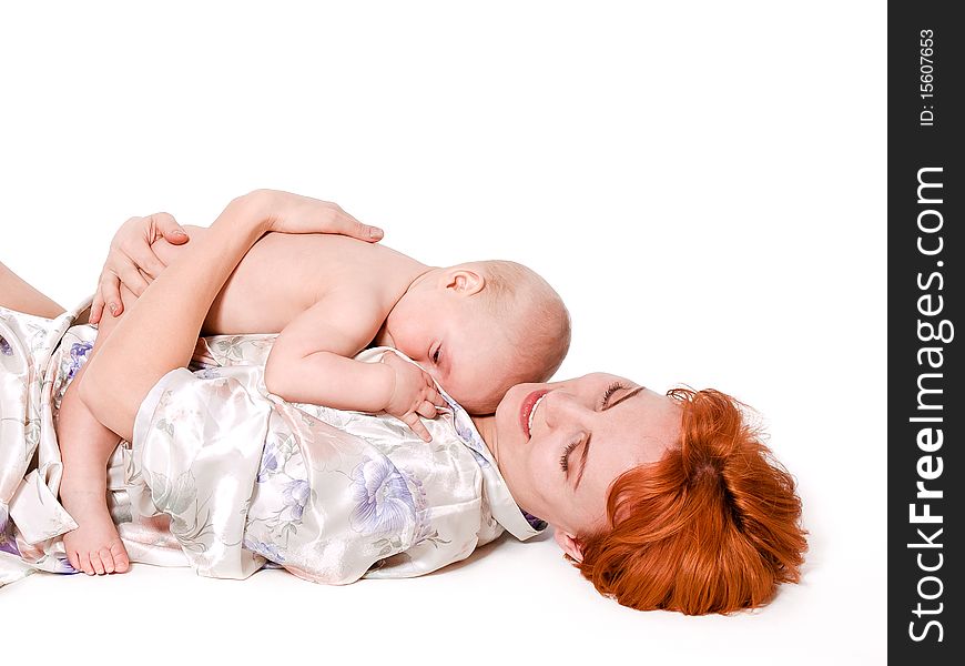 Cute 10 months baby boy lying on his mother. Isolated on white background