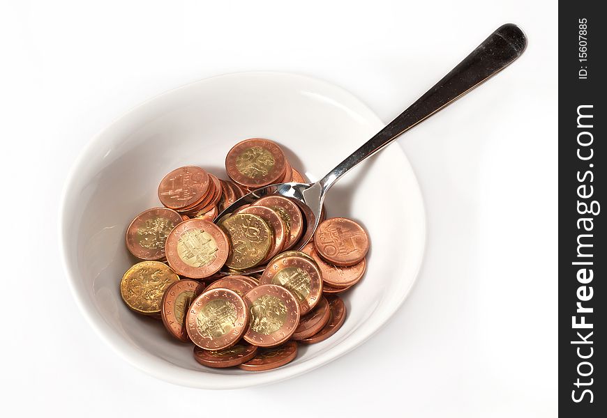 A bowl filled with metal money and with spoon ladling the money. A bowl filled with metal money and with spoon ladling the money.