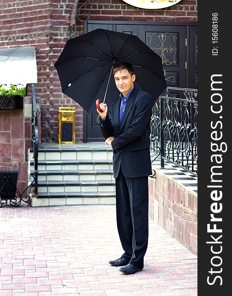 Man in black with an umbrella