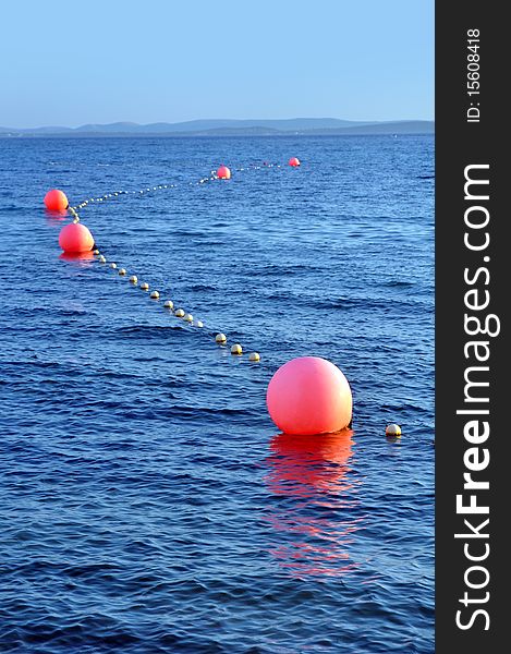 Several buoys marking a safe way for boats