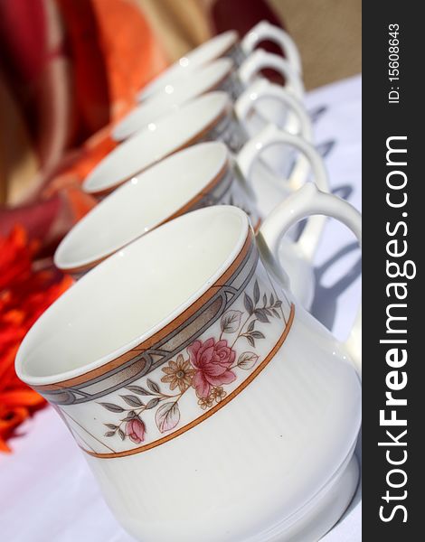 Decorative tea cups in a row with colorful background