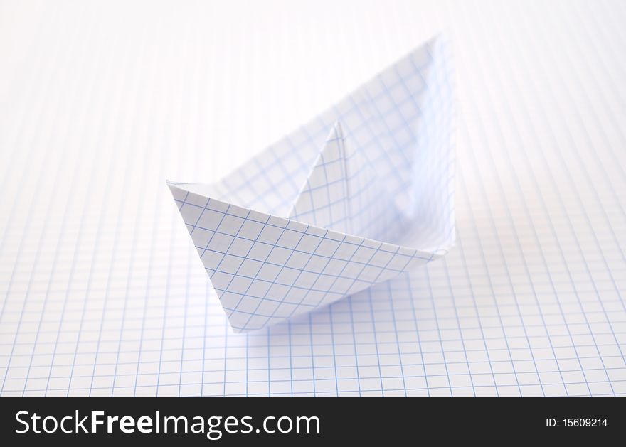 Paper ship on meshed background