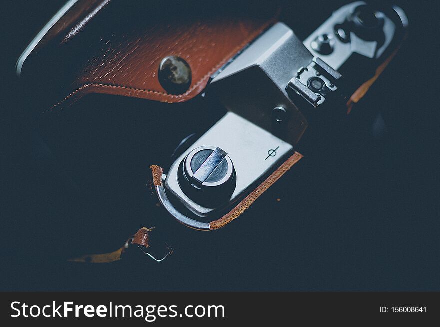 Vintage camera in a leather case. View from above. Soft focus.