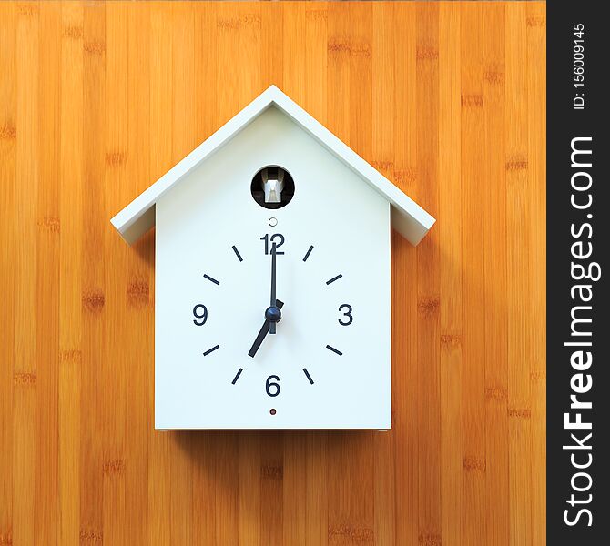 Isolated object, Vintage white wall clock with birdhouse style on wooden background