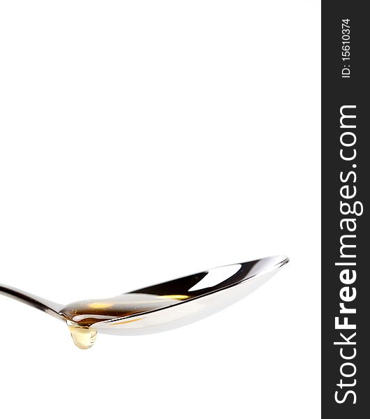 Spoon with dripping honey isolated on white. Spoon with dripping honey isolated on white