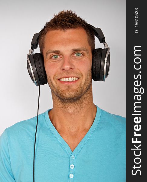 Portrait of young man with headphones, smiling happy