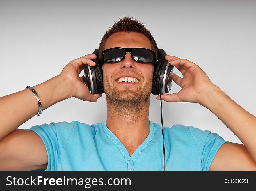 Portrait of young man with headphones, smiling happy. Portrait of young man with headphones, smiling happy.