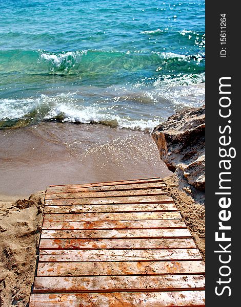 Waves on sandy beach in greek island