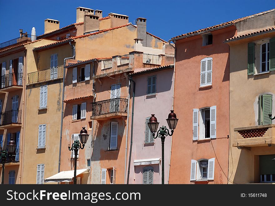 Lavender blue colored shutters on yellow stucco