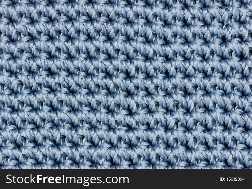 Blue knitted texture for backgrounds. Blue knitted texture for backgrounds.