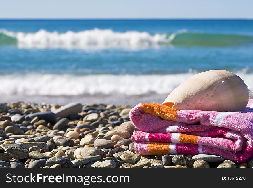 Close up of a towel and shell on a beach. Close up of a towel and shell on a beach.