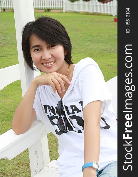 Thai woman sitting on a bench