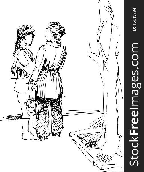 two girls stand at a tree and speak. two girls stand at a tree and speak