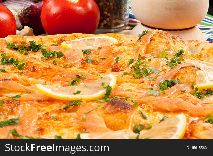 Delicious pizza with salmon and vegetables. Delicious pizza with salmon and vegetables