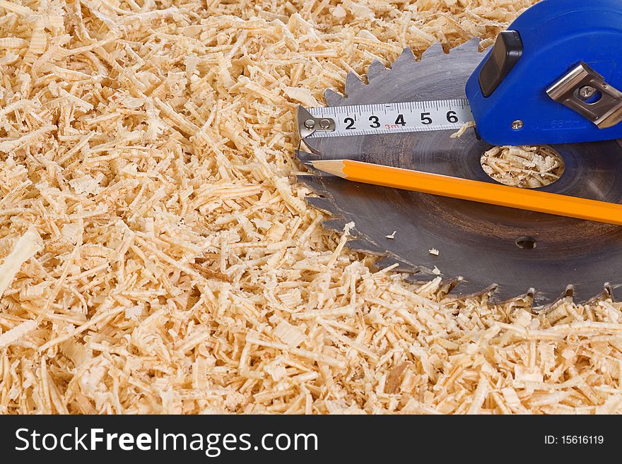 Tape measure and pencil on sawdust