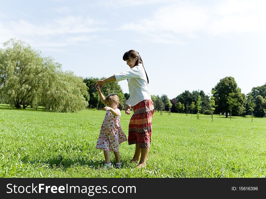 Mother and daughter having fun on meadow. Mother and daughter having fun on meadow