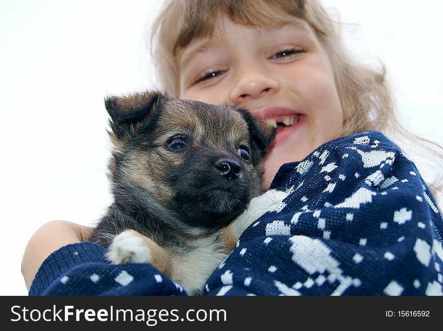 The girl holds a puppy