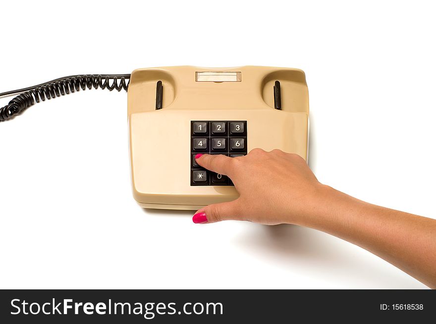 Female finger presses the button on the old phone isolated on white background. Female finger presses the button on the old phone isolated on white background.