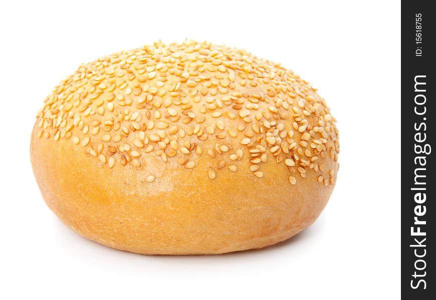 One tasty baked rolls with sesame, isolated on a white background