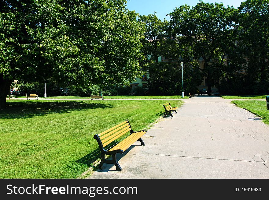 Bench and lamps in tranquil green city park