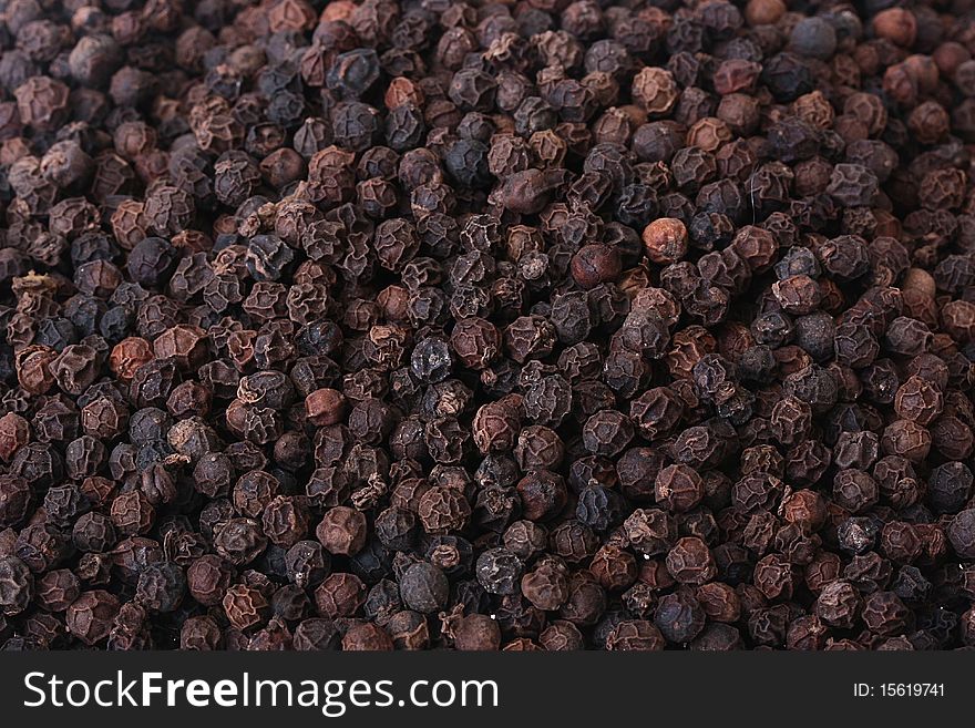 Spice - black dried pepper peas, a black background. Spice - black dried pepper peas, a black background.