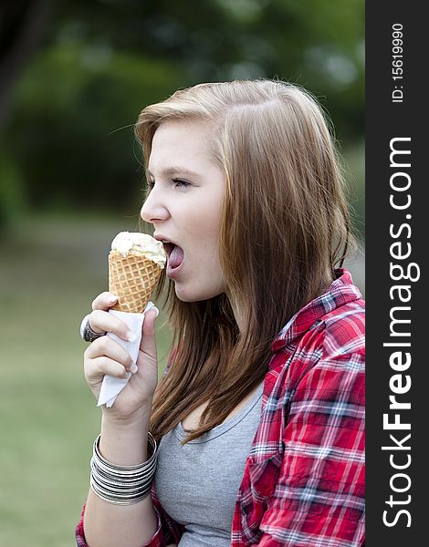 Teenage girl eating ice cream outdoors